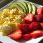 Scrambled eggs with avocado and strawberries